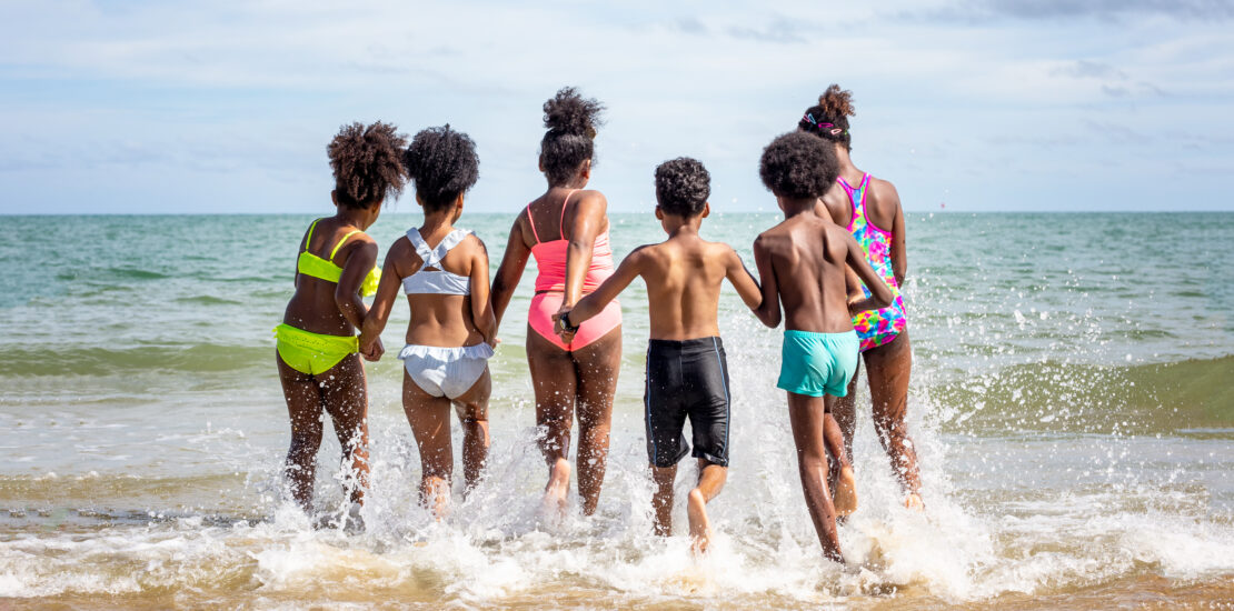 kids running into the ocean